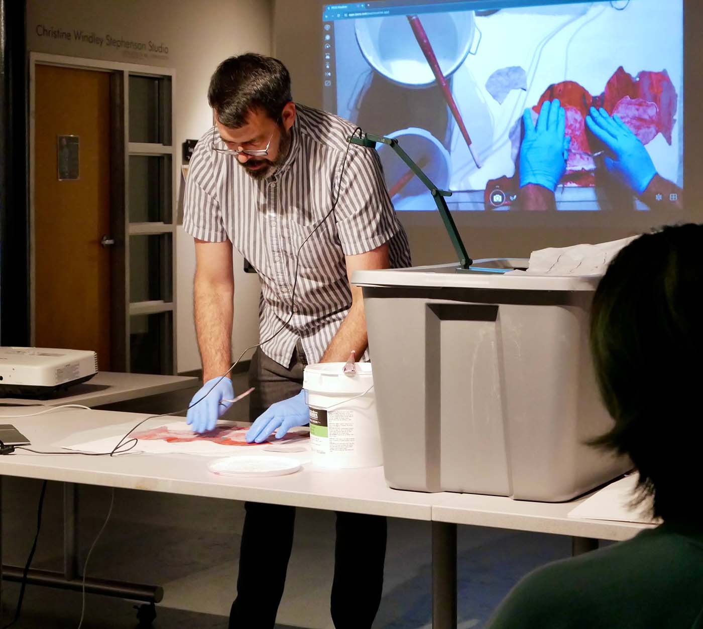 Artist showing work on projector